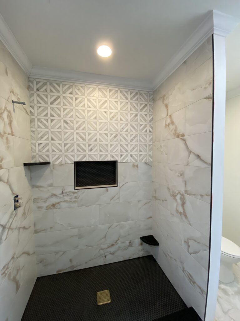 Calacatta geometric mosaic tile shower by Palacios Installation