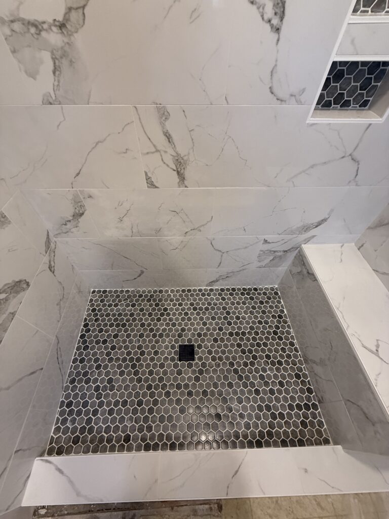 Hexagon mosaic tile niche in a custom shower