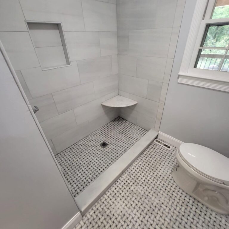 Tile shower with a corner seat and basketweave mosaic floor, Chattanooga, TN by Palacios Installation