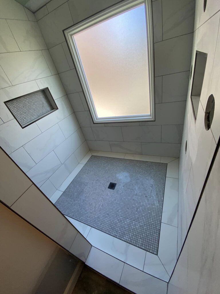 Walk-in tile shower under a skylight with recessed niches, Chattanooga, TN by Palacios Installation